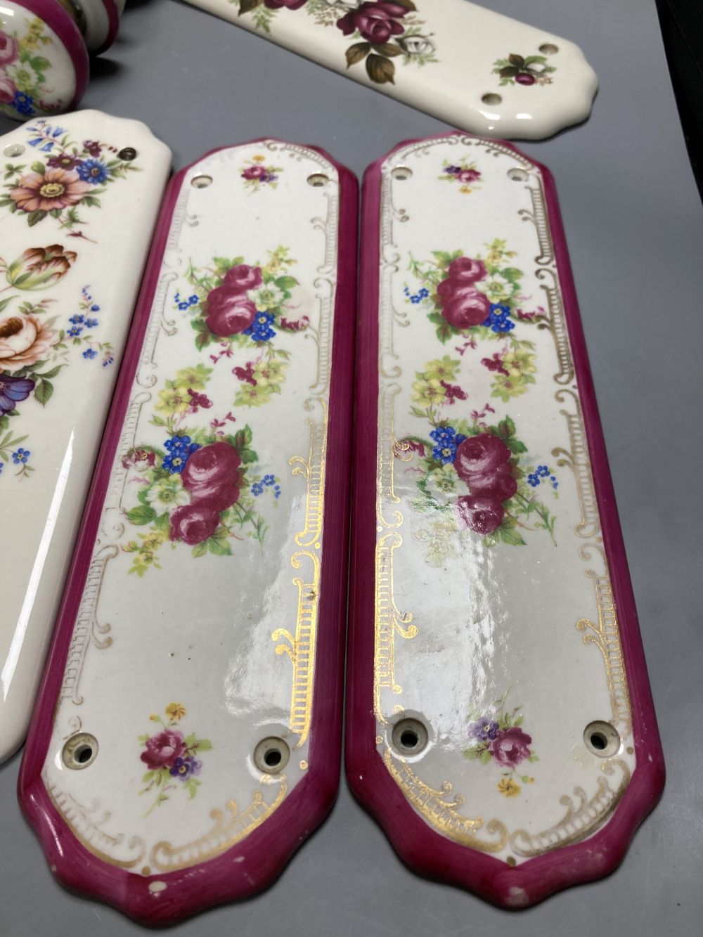Five pairs of French porcelain door handles and ten porcelain door plates
